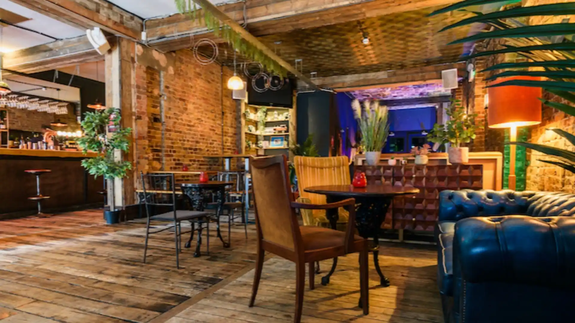 Old school armchairs, wooden flooring and exposed ceilings