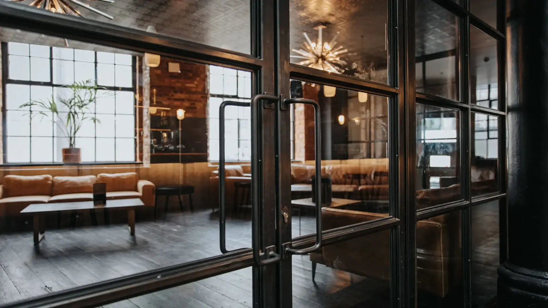 Industrial glass doors framed with steel show into a private room