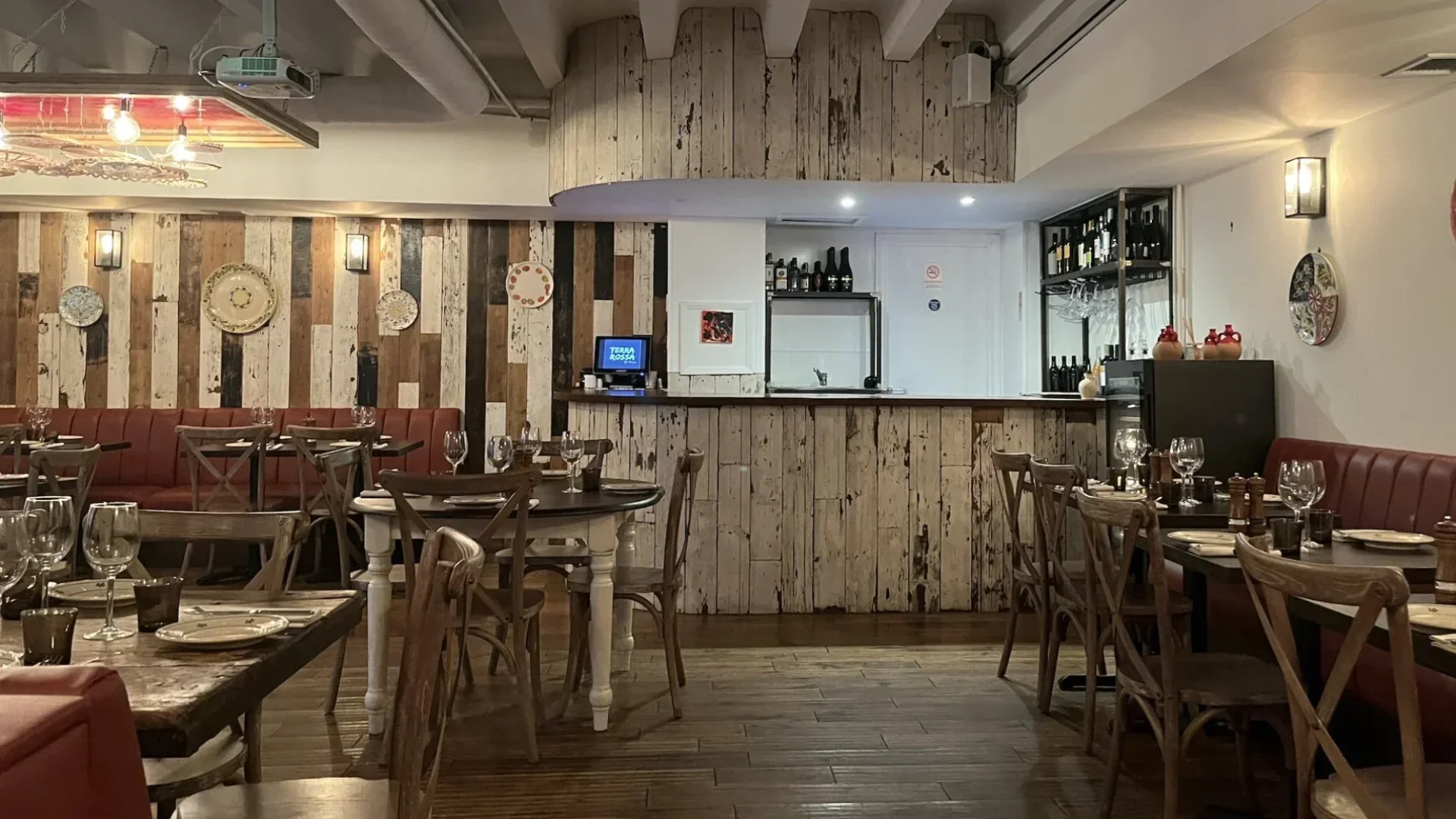 Rough, rustic exposed wood lines the floor, bar and tables