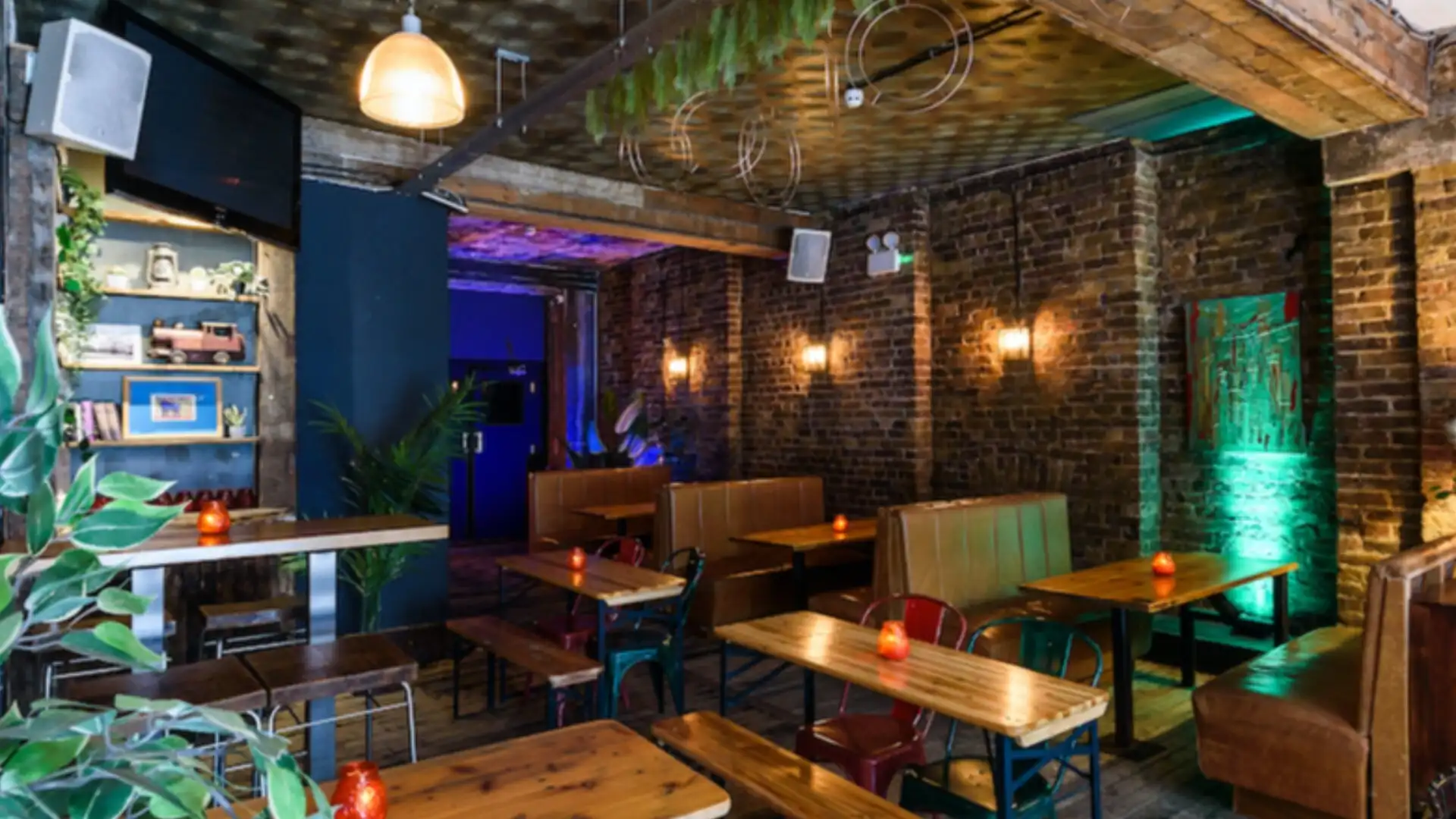 Chilled, warm seating area with a vibrant blue, neon style area in the background