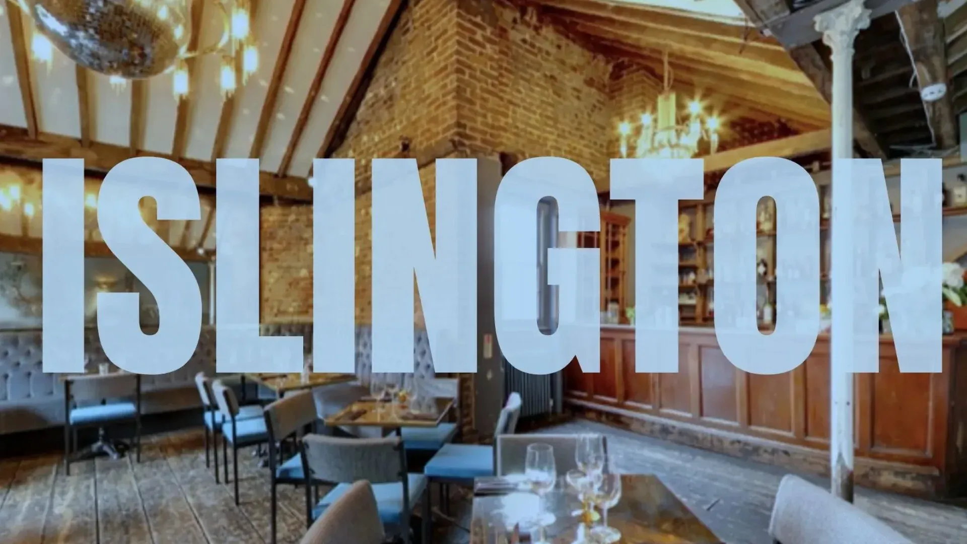 Exposed brickwork, and roof beams witha mahogany bar show a rustic loft in Islington