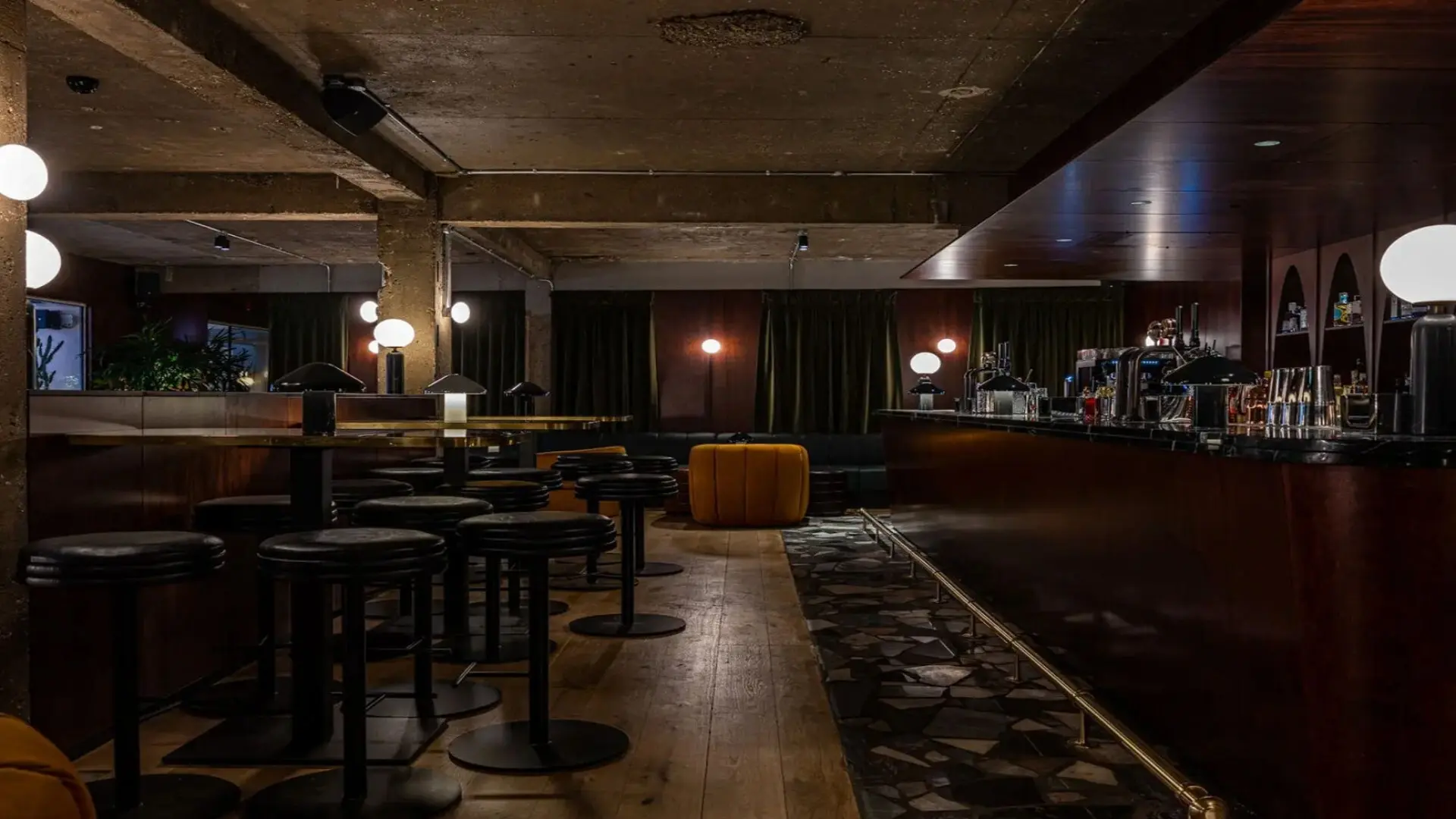 Wooden flooring, partitioned with black marble in luxury cockatail bar in Mansion House