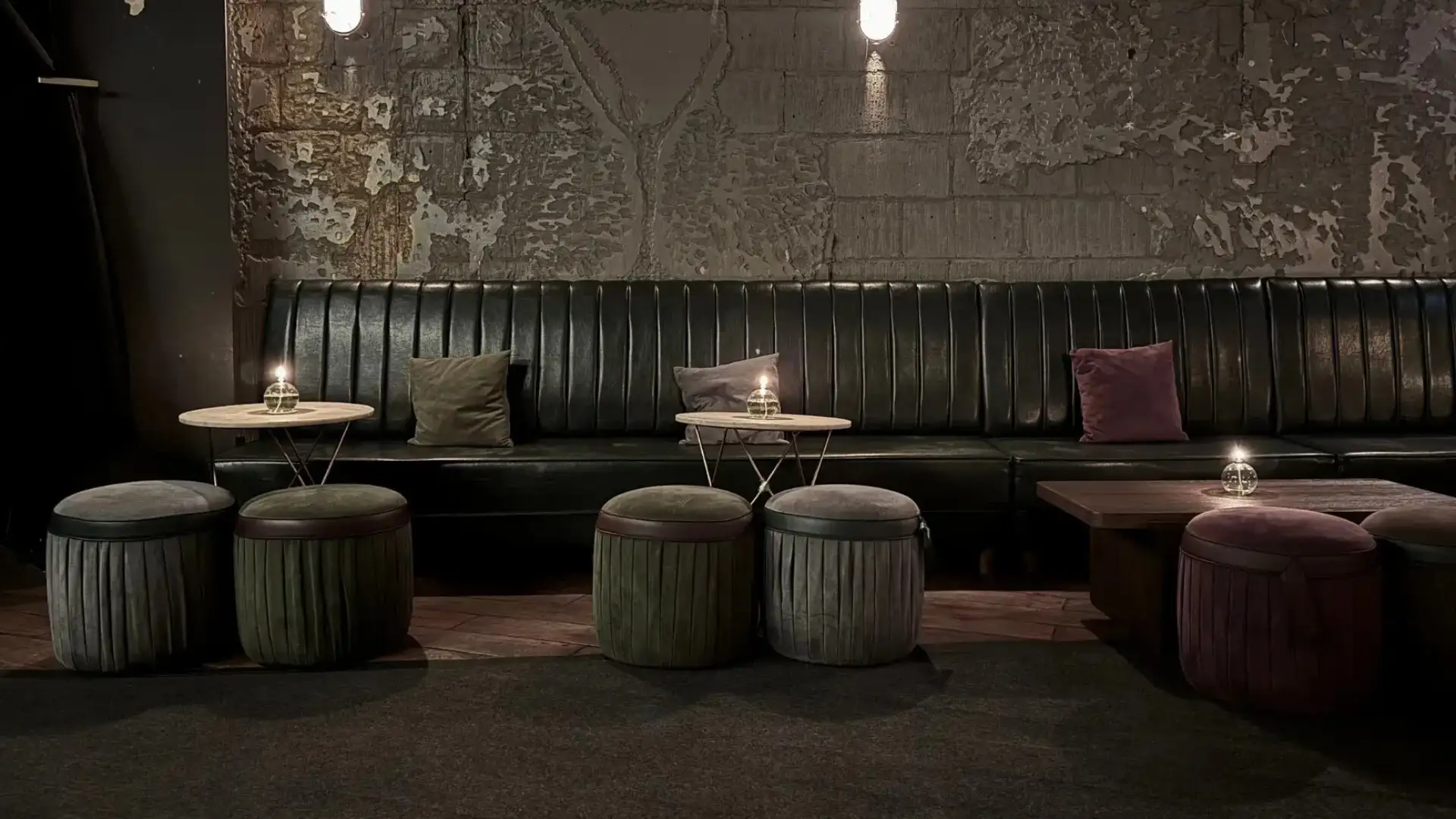 Dimly lit, bar stools at the tables in industrial style setting