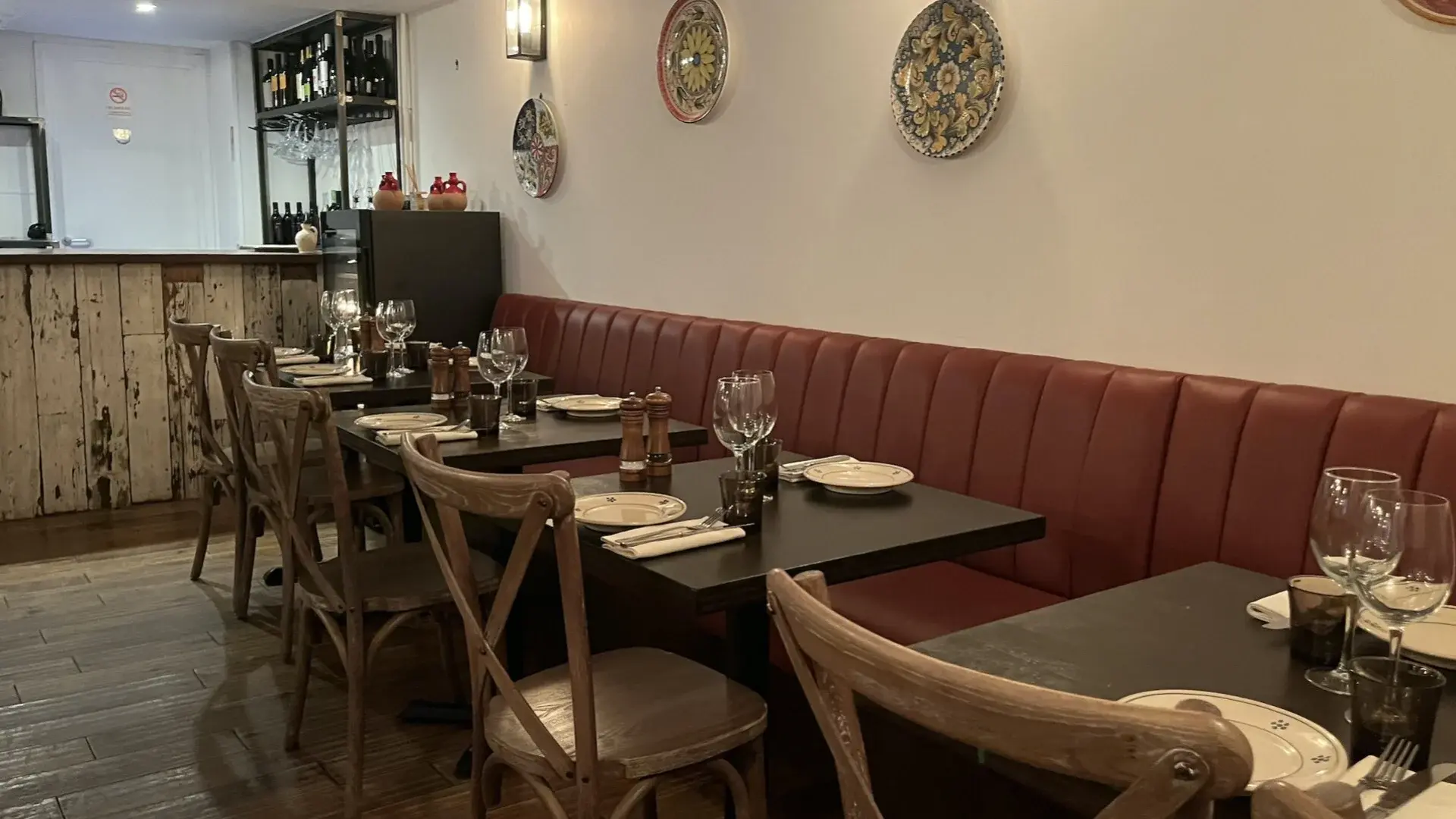 Clean, tidy and well organised table setting and red banquette seating